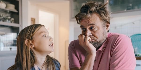 Father and daughter sitting down having their first period talk